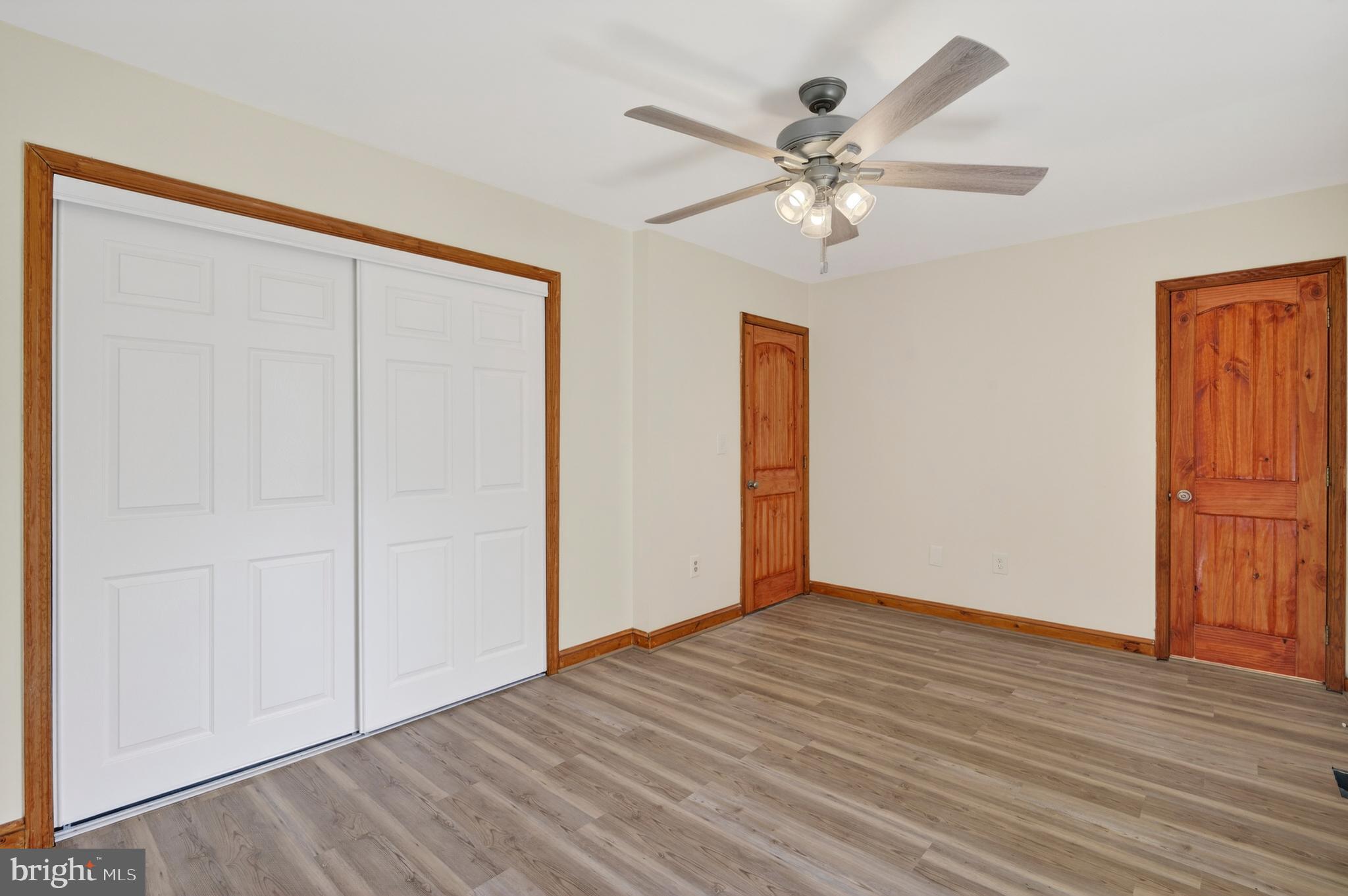 4037 1st Street Chesapeake Beach, MD 20732 - Photo 21 of 26 a view of an empty room with wooden floor