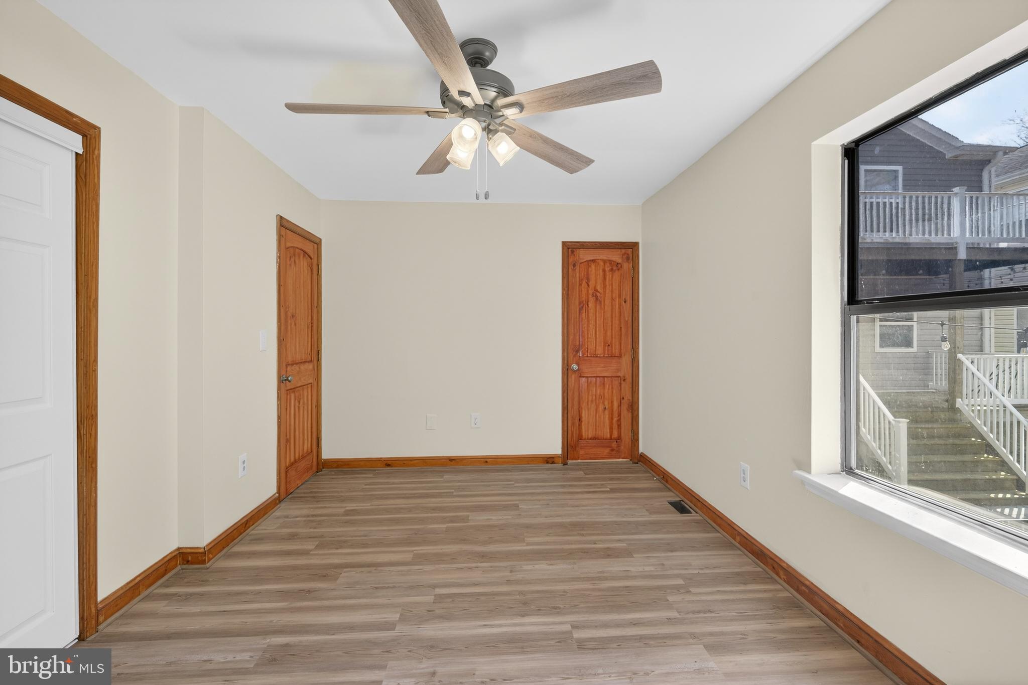 4037 1st Street Chesapeake Beach, MD 20732 - Photo 6 of 26 a view of an empty room with wooden floor and a window