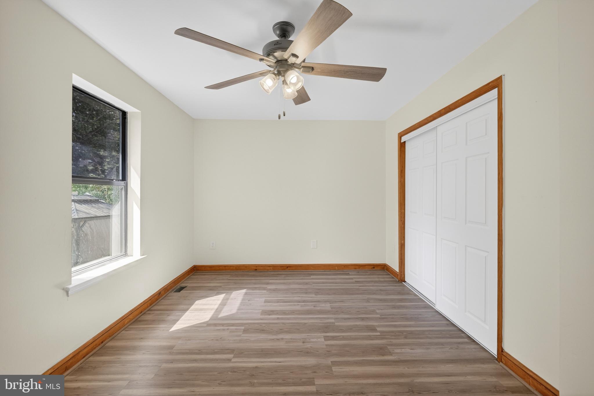 4037 1st Street Chesapeake Beach, MD 20732 - Photo 7 of 26 wooden floor in an empty room with a window