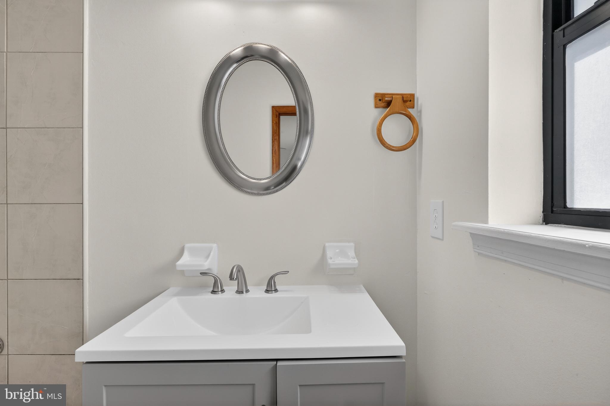 4037 1st Street Chesapeake Beach, MD 20732 - Photo 9 of 26 a bathroom with a sink and a mirror