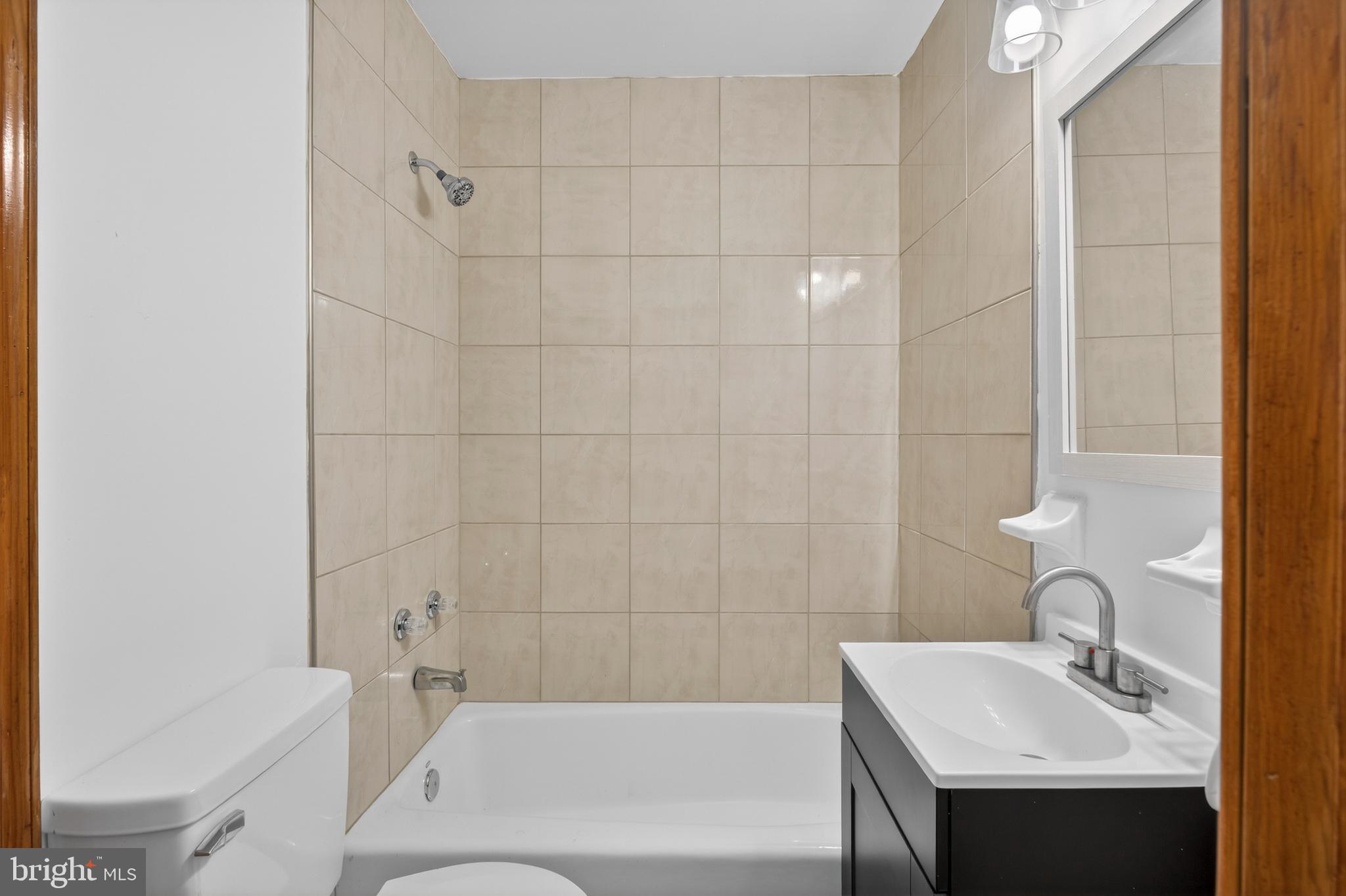 4037 1st Street Chesapeake Beach, MD 20732 - Photo 10 of 26 a bathroom with a sink and a bathtub