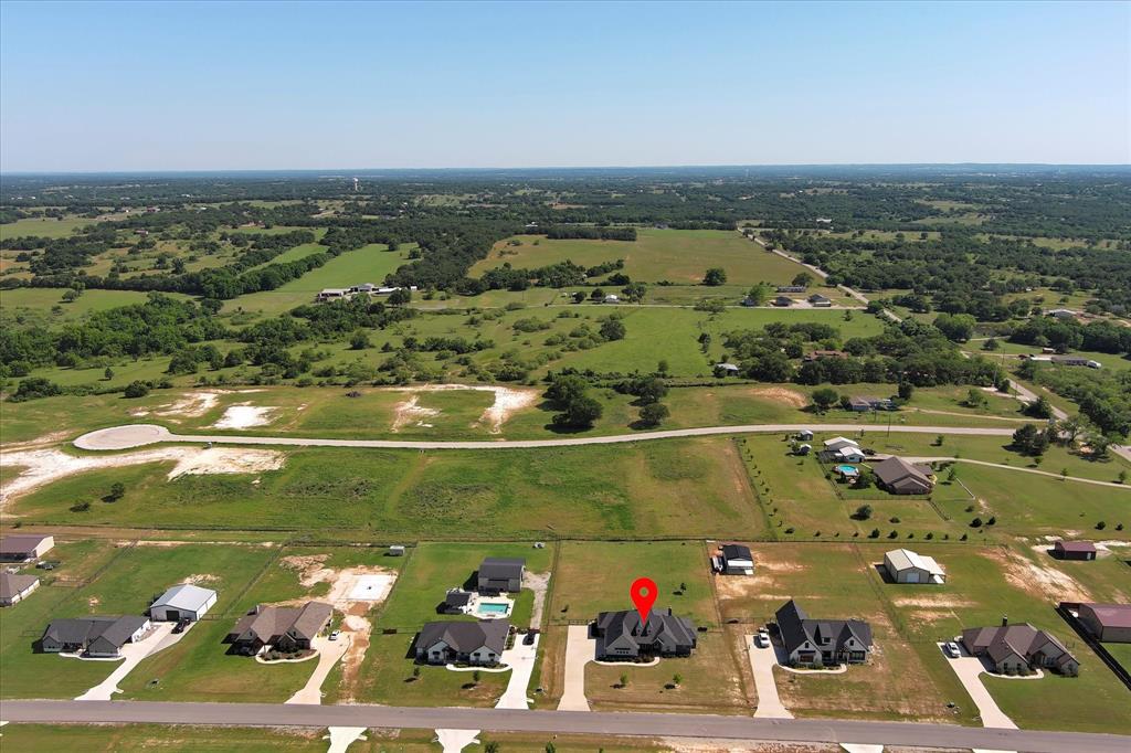 112 Friendship Way Boyd, TX 76023 - Photo 27 of 29 Aerial perspective showcasing a single-family residence with a dark roof and light-colored exterior, situated on a manicured lot
