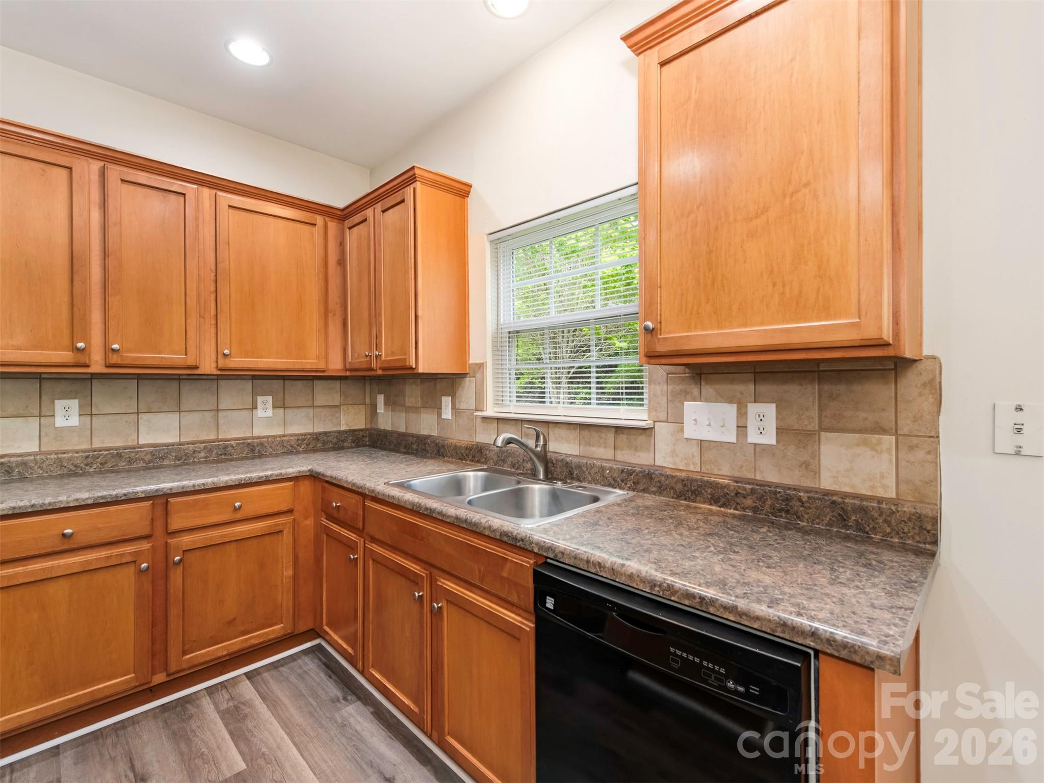 6507 Hermsley Road Charlotte, NC 28278 - Photo 11 of 40 a kitchen with stainless steel appliances granite countertop a sink a stove and cabinets
