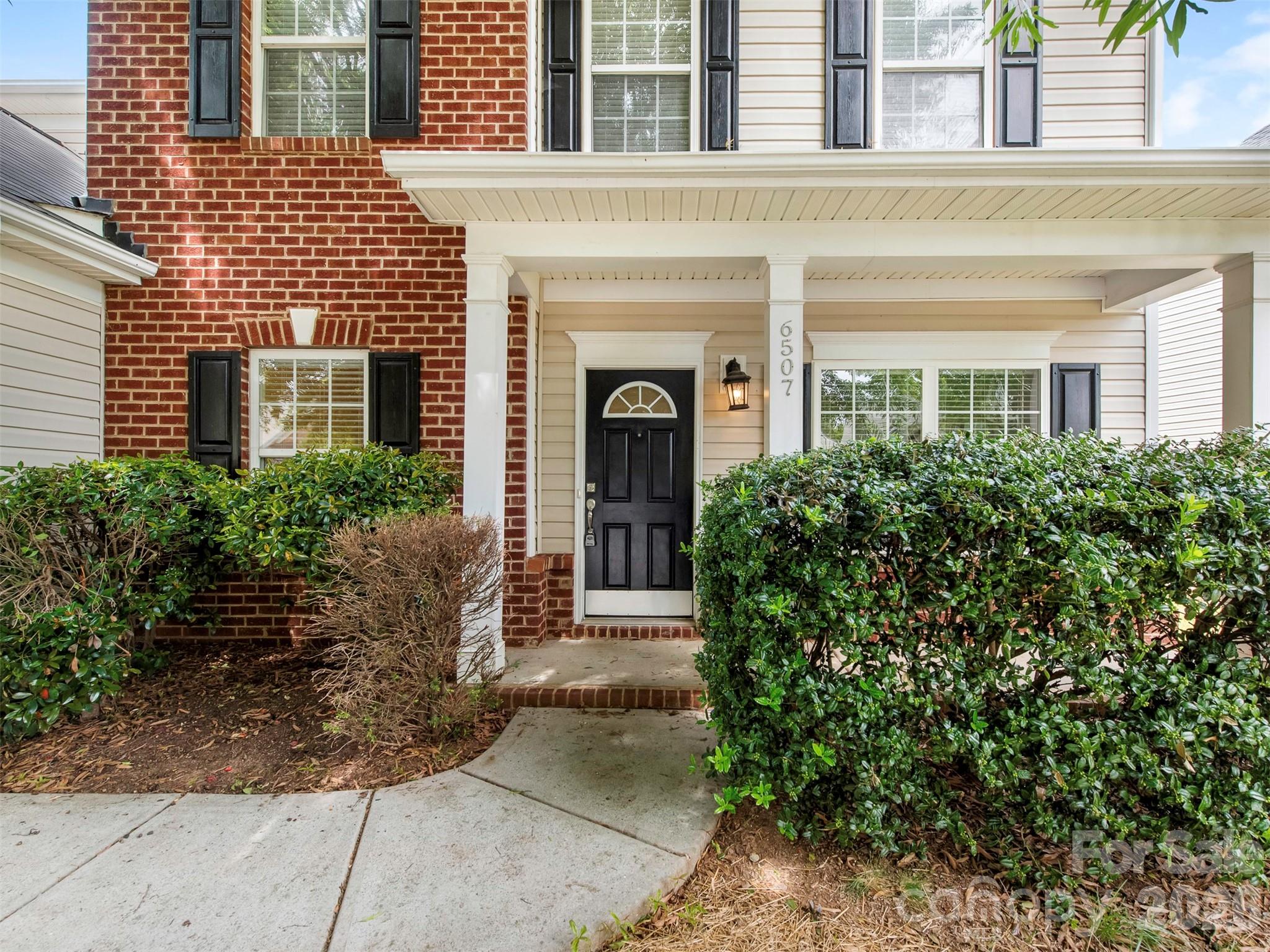 6507 Hermsley Road Charlotte, NC 28278 - Photo 2 of 40 front view of a brick house with a large windows