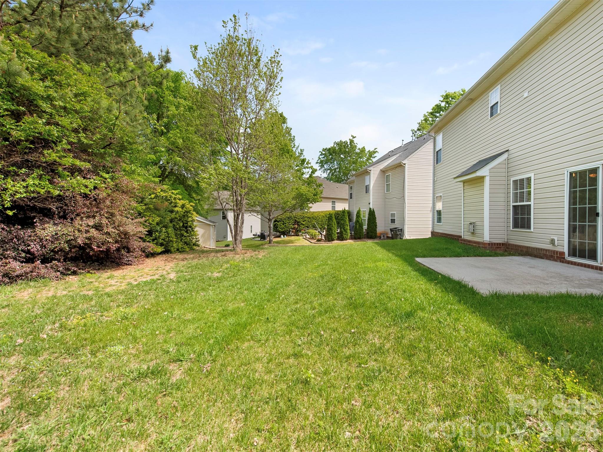 6507 Hermsley Road Charlotte, NC 28278 - Photo 23 of 40 a backyard of a house with large trees and outdoor seating