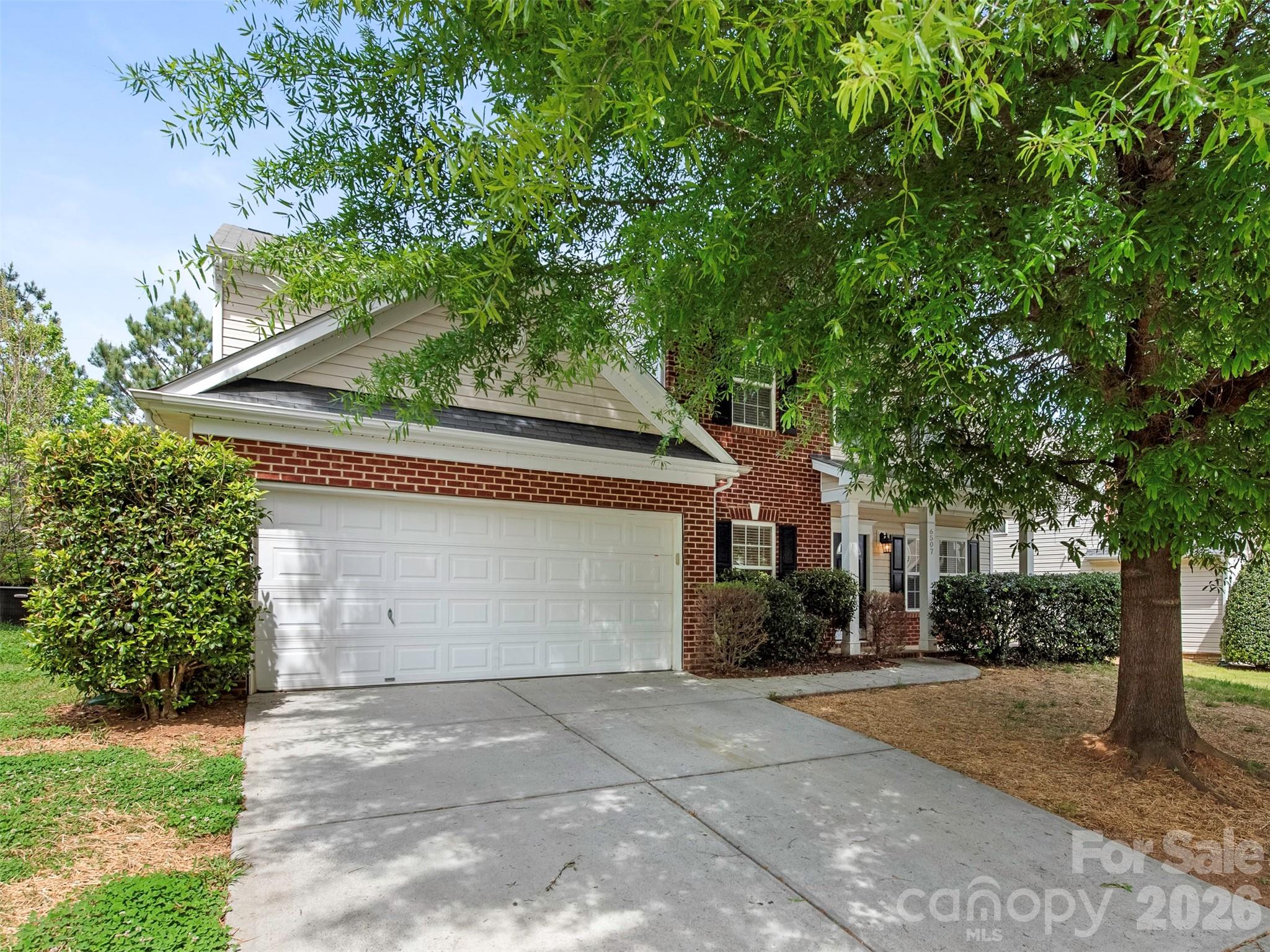 6507 Hermsley Road Charlotte, NC 28278 - Photo 27 of 40 a front view of a house with a yard and garage