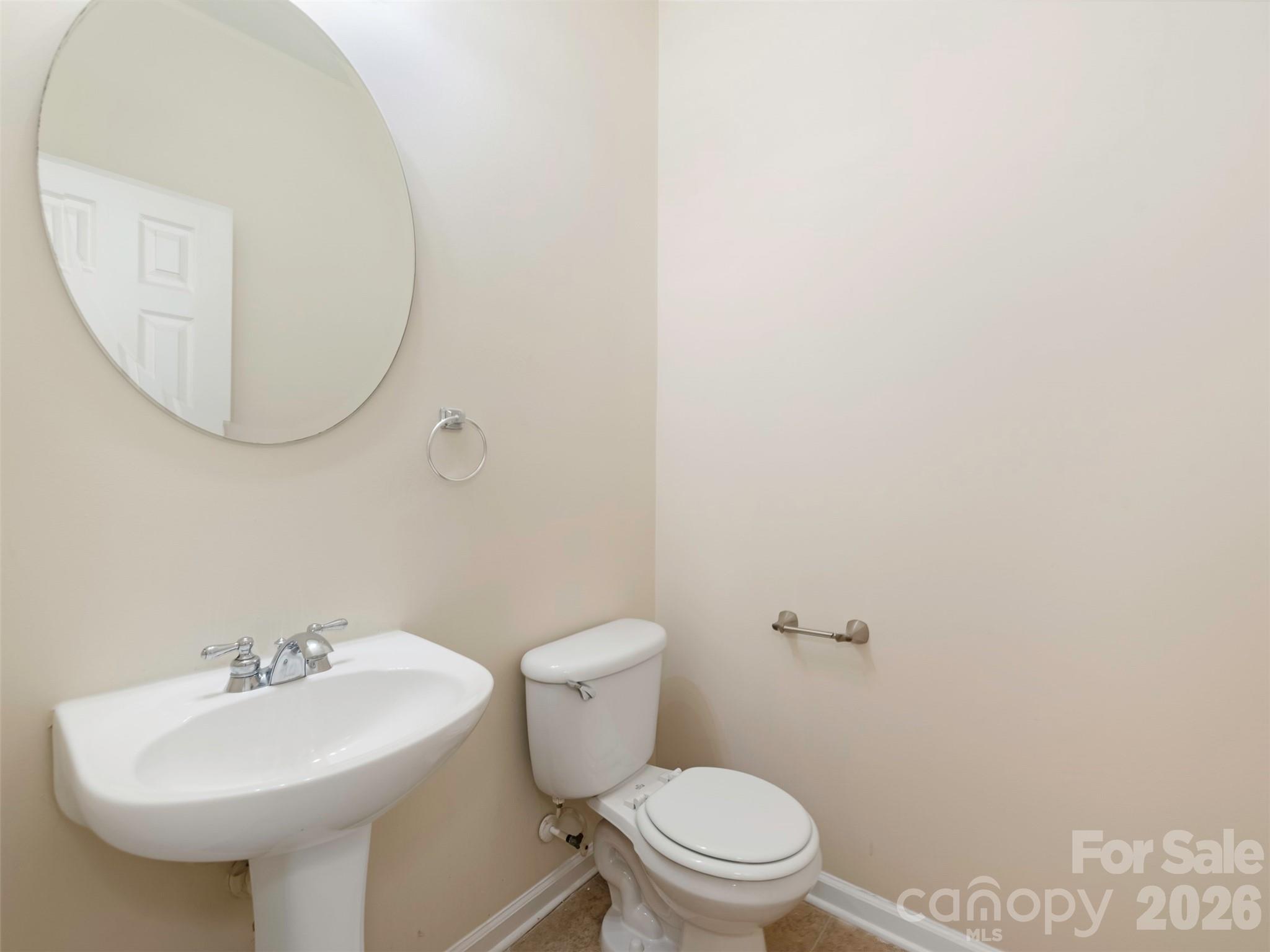6507 Hermsley Road Charlotte, NC 28278 - Photo 30 of 40 a bathroom with a sink a toilet and mirror
