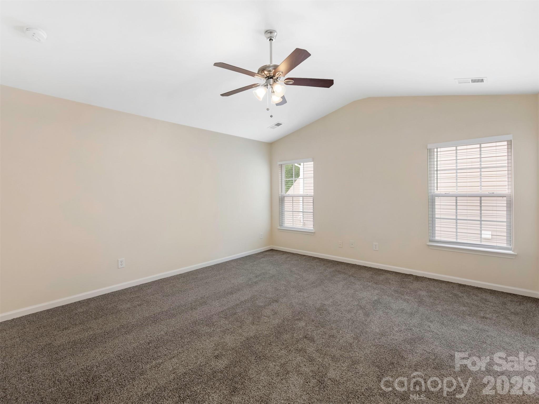 6507 Hermsley Road Charlotte, NC 28278 - Photo 36 of 40 an empty room with windows and fan