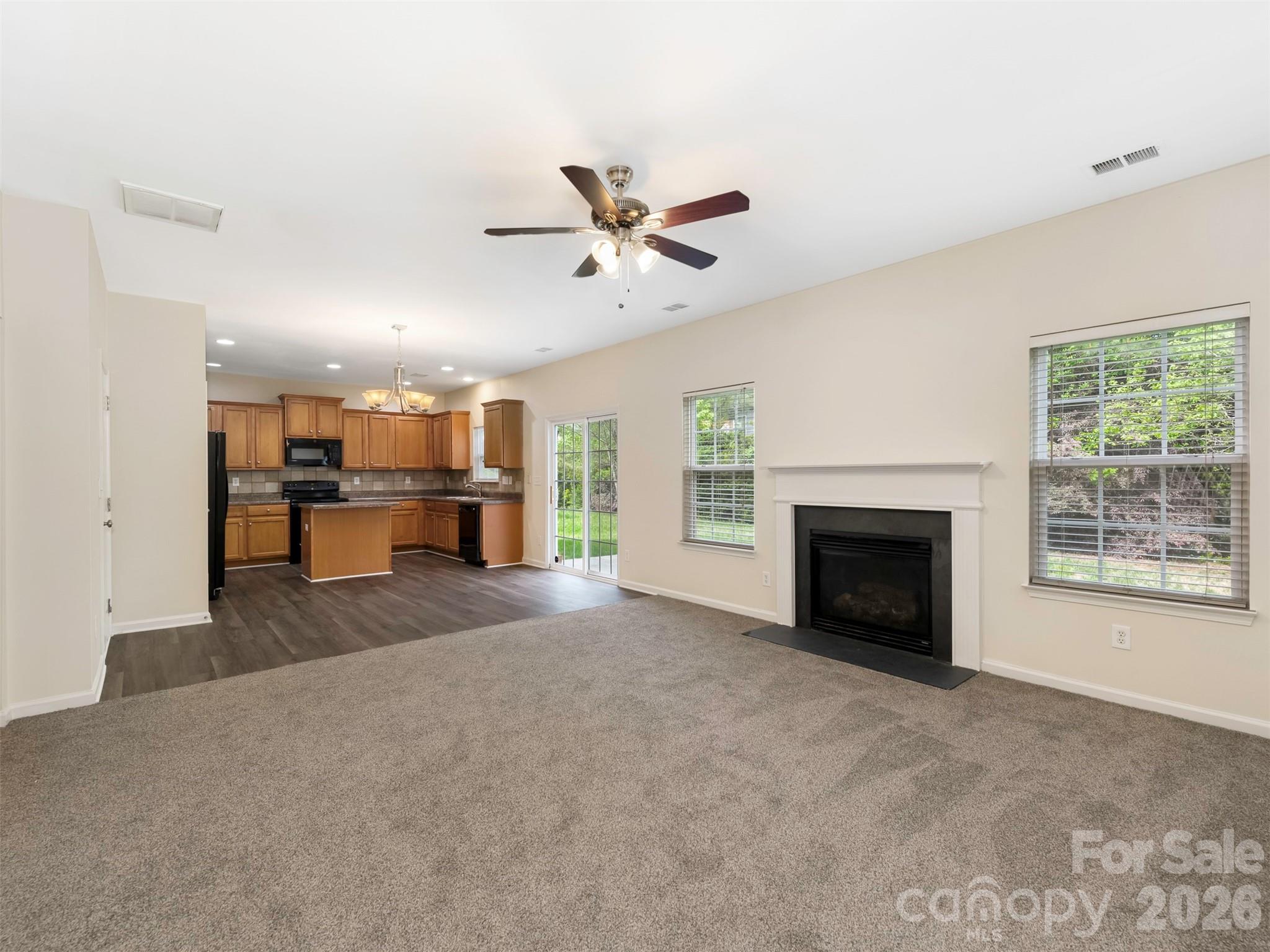 6507 Hermsley Road Charlotte, NC 28278 - Photo 5 of 40 a view of an empty room with a fireplace and a window