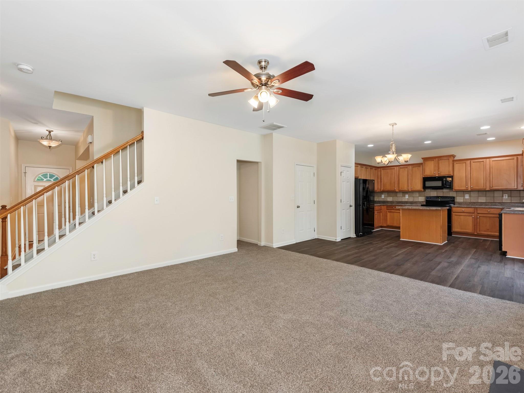 6507 Hermsley Road Charlotte, NC 28278 - Photo 6 of 40 a view of an empty room with a window and a kitchen