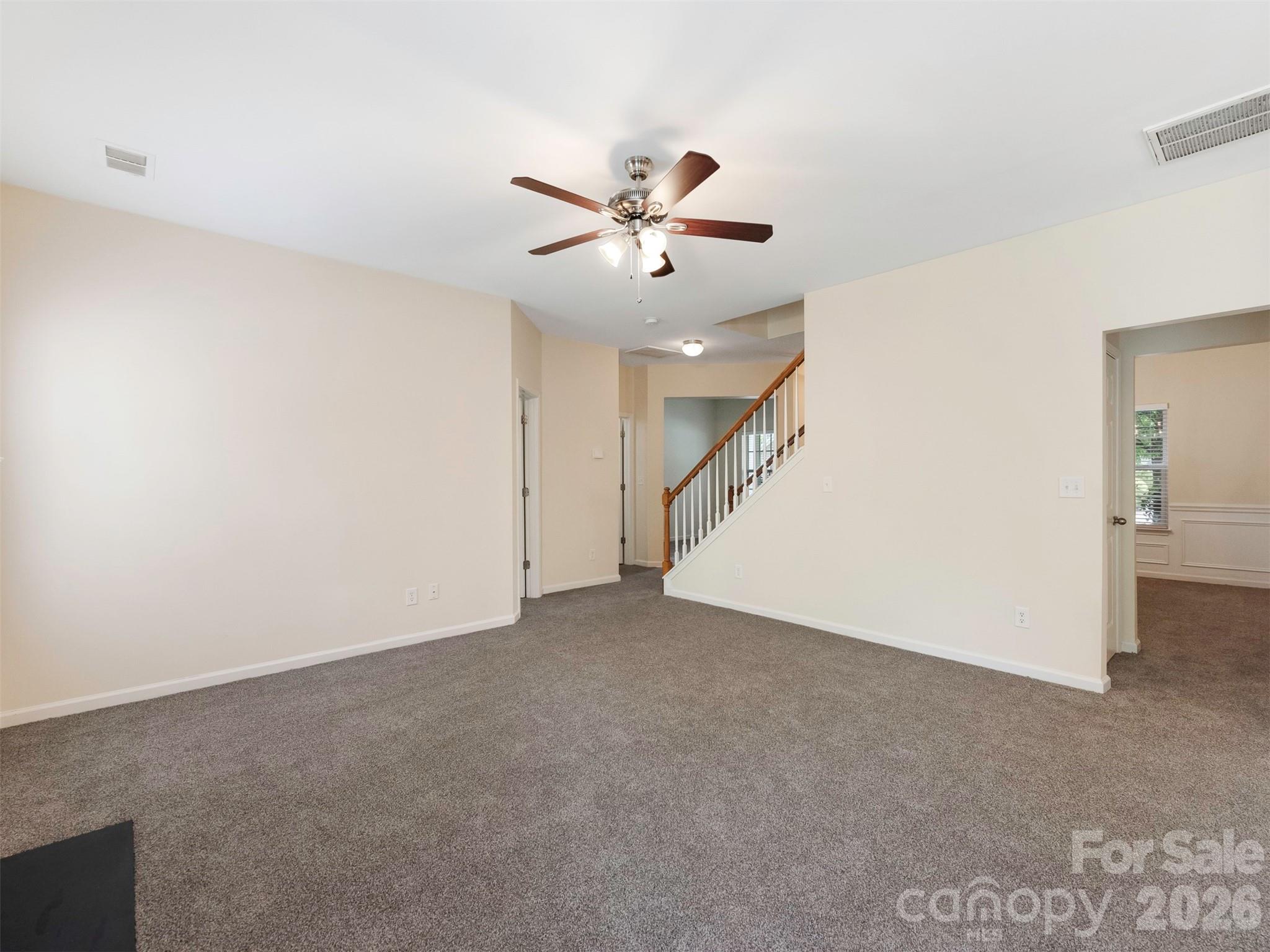 6507 Hermsley Road Charlotte, NC 28278 - Photo 7 of 40 a view of an empty room with a ceiling fan