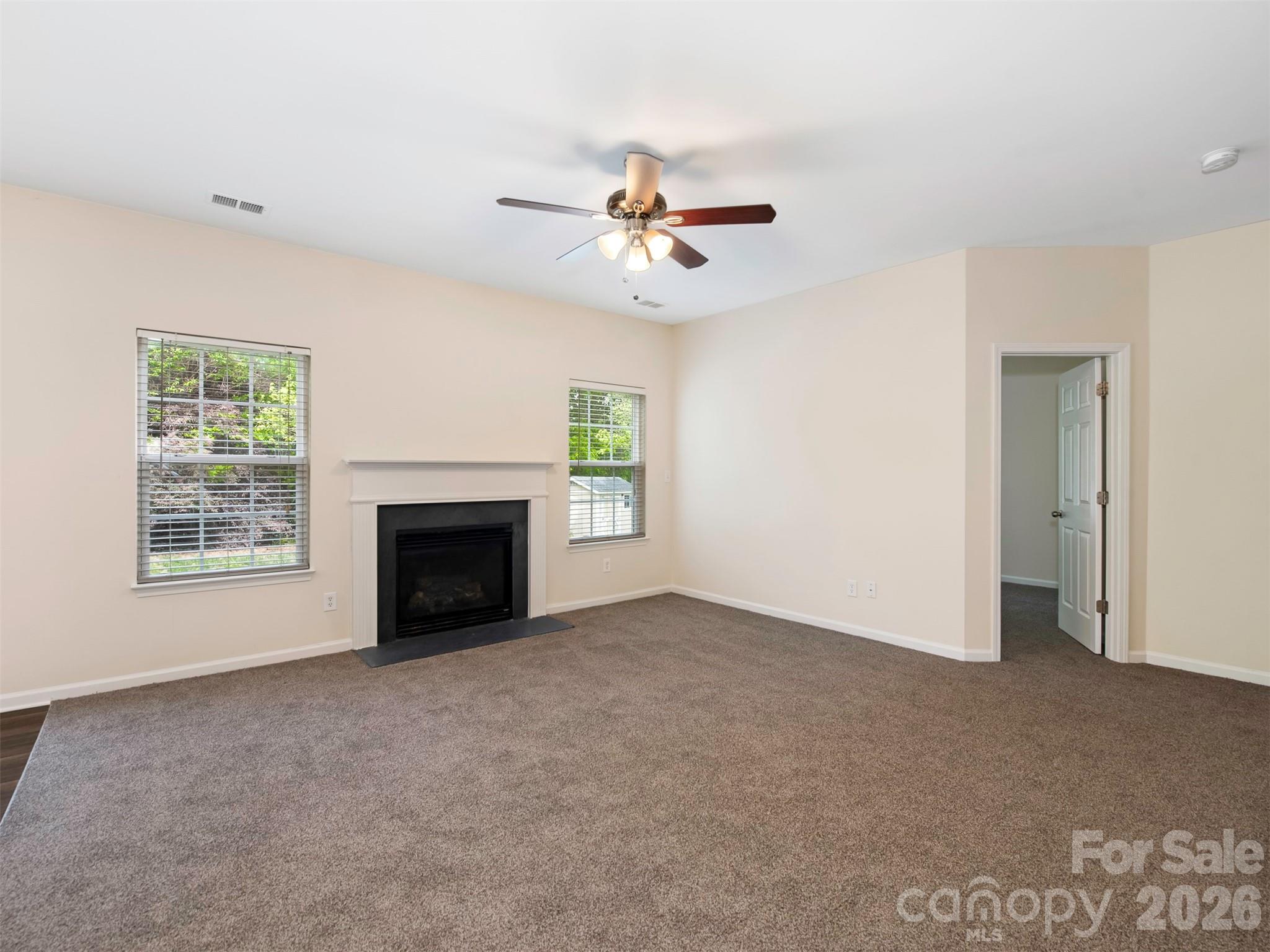 6507 Hermsley Road Charlotte, NC 28278 - Photo 8 of 40 an empty room with windows and a fireplace