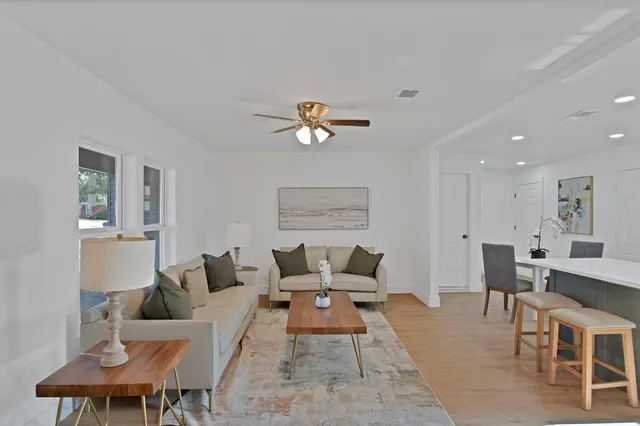 a living room with furniture and a chandelier