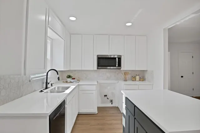 a kitchen with a dining table chairs workspace and a sink