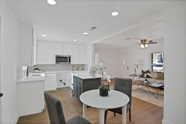 a view of a dining room with furniture and wooden floor