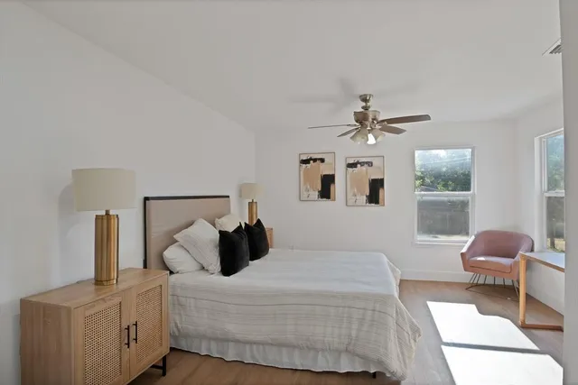 a bedroom with a bed and a chandelier