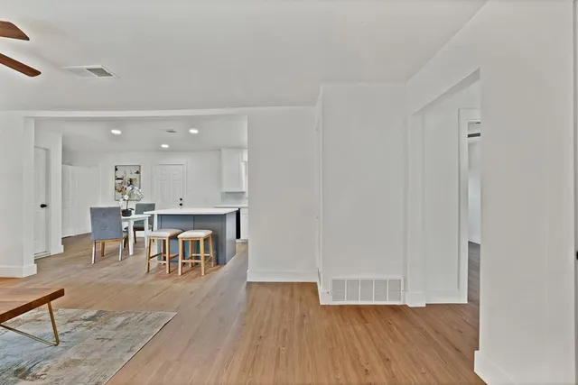 a view of a dining room with furniture and wooden floor