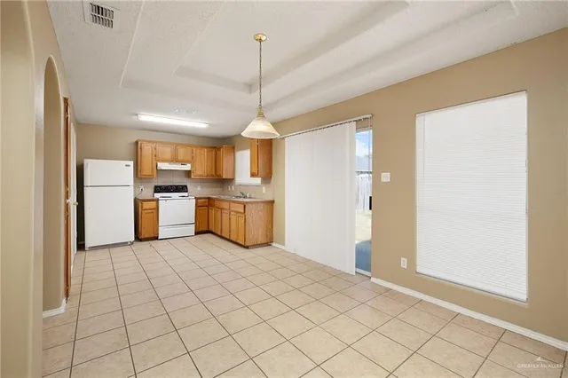 a view of a kitchen with microwave and refrigerator