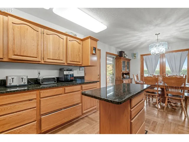 a kitchen with stainless steel appliances granite countertop a sink a stove and cabinets