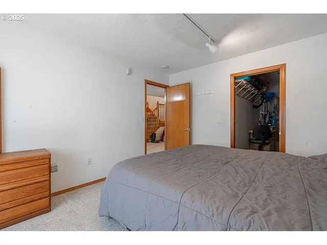 a bedroom with a bed and a painting on the wall