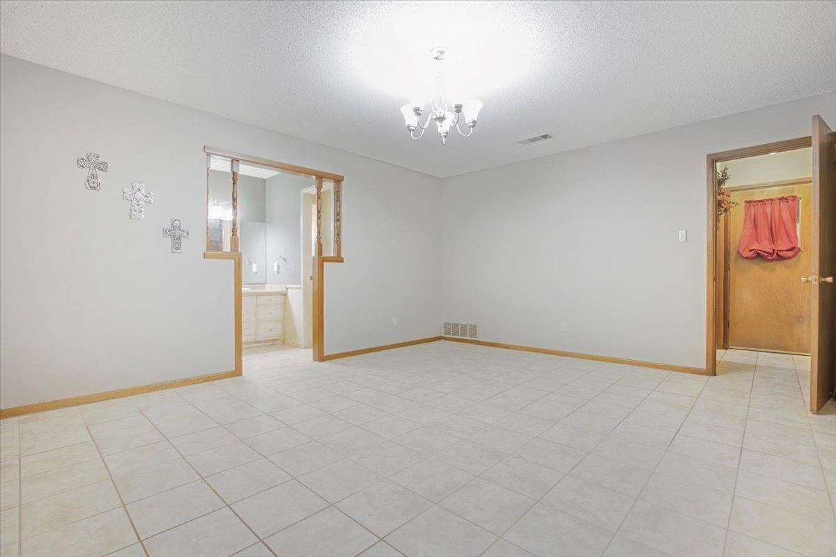 205 Smith Avenue New Home, TX 79381 - Photo 14 of 27 an empty room with chandelier fan