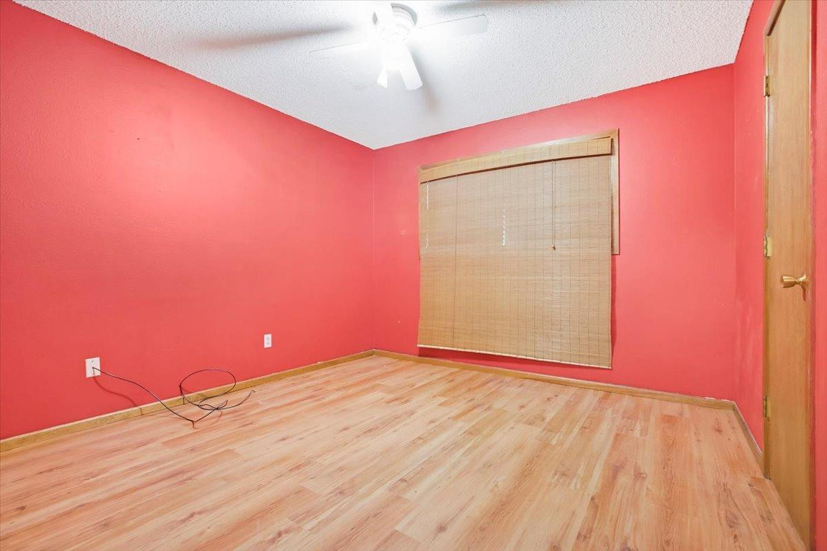 205 Smith Avenue New Home, TX 79381 - Photo 22 of 27 a view of empty room with wooden floor and fan