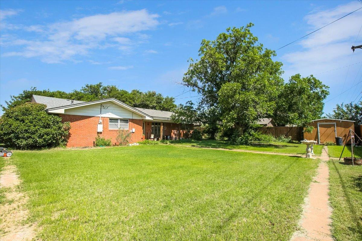 205 Smith Avenue New Home, TX 79381 - Photo 26 of 27 a front view of a house with a yard
