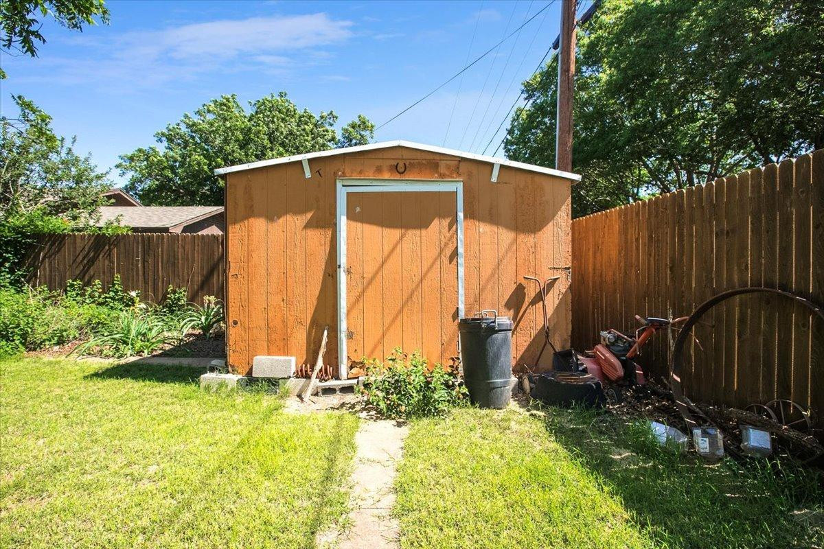 205 Smith Avenue New Home, TX 79381 - Photo 27 of 27 a view of a backyard with a small cabin