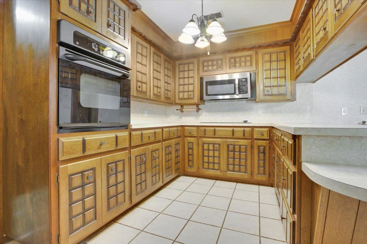 205 Smith Avenue New Home, TX 79381 - Photo 6 of 27 a kitchen with stainless steel appliances granite countertop a sink and cabinets