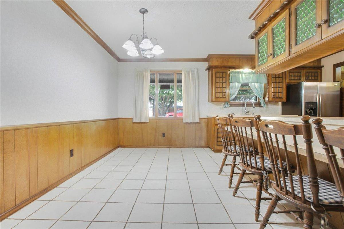 205 Smith Avenue New Home, TX 79381 - Photo 8 of 27 a view of a dining room with furniture and chandelier