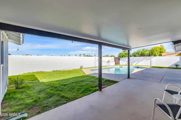 a view of a swimming pool with a yard