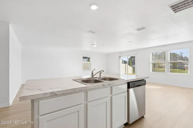 a kitchen with stainless steel appliances a refrigerator stove and microwave