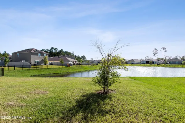 a front view of a house with a big yard