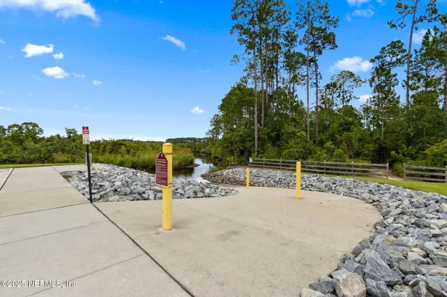 a view of a patio with a table and chairs under an umbrella