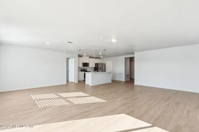 a view of a kitchen with a sink and a refrigerator