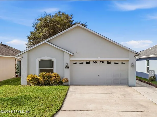 a view of a house with a yard