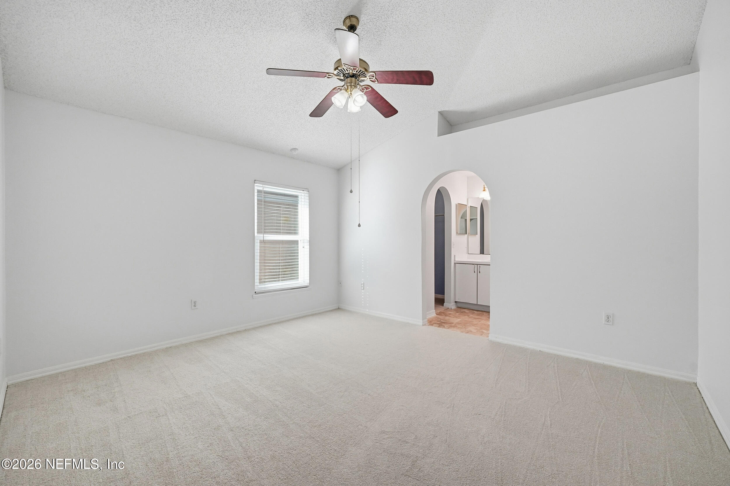 3380 Net Court Jacksonville, FL 32277 - Photo 12 of 20 an empty room with chandelier fan and windows