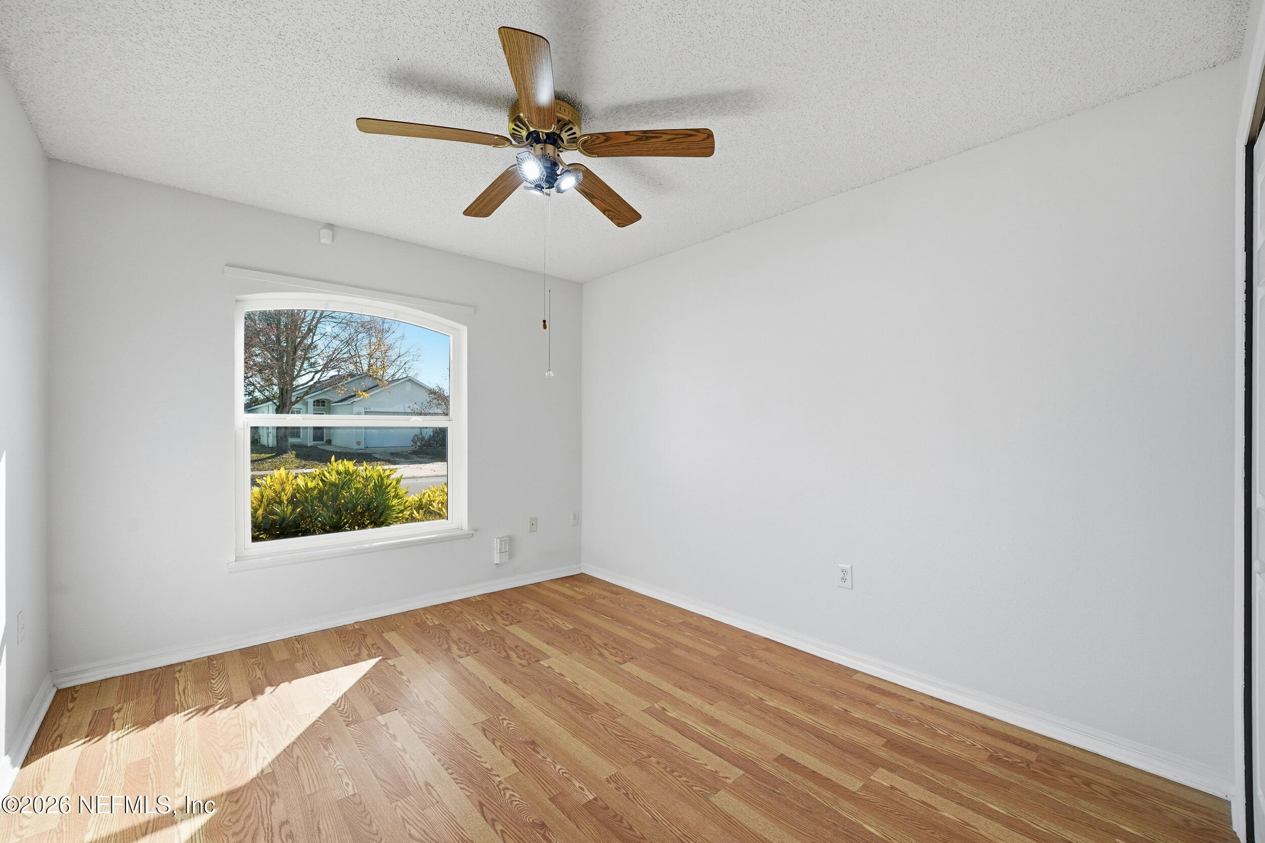 3380 Net Court Jacksonville, FL 32277 - Photo 14 of 20 a view of empty room with wooden floor and fan