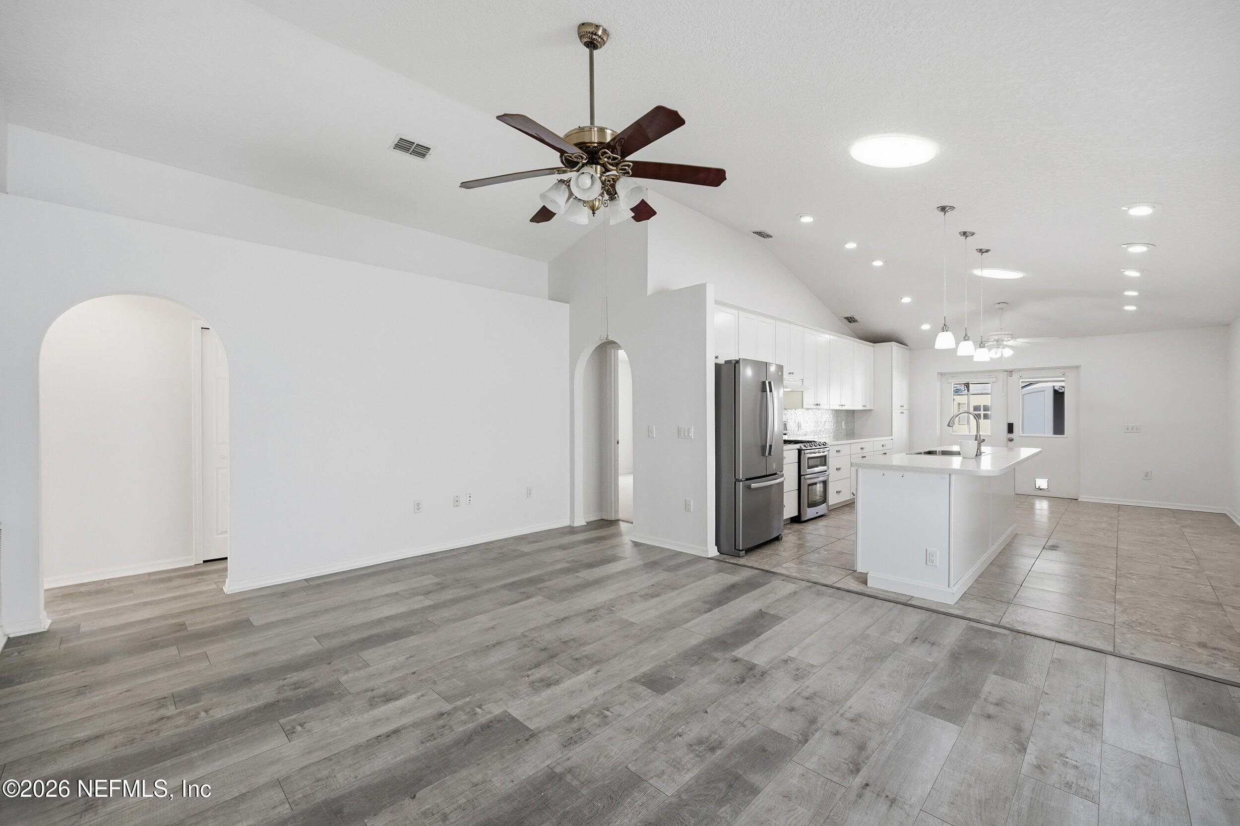 3380 Net Court Jacksonville, FL 32277 - Photo 3 of 20 a view of a kitchen with a refrigerator and a chandelier