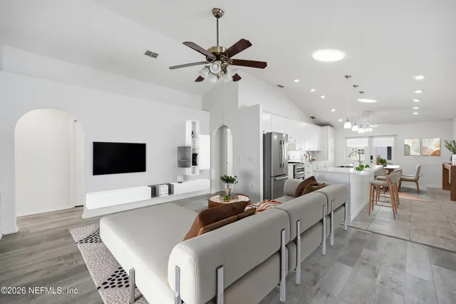 a living room with furniture and a flat screen tv