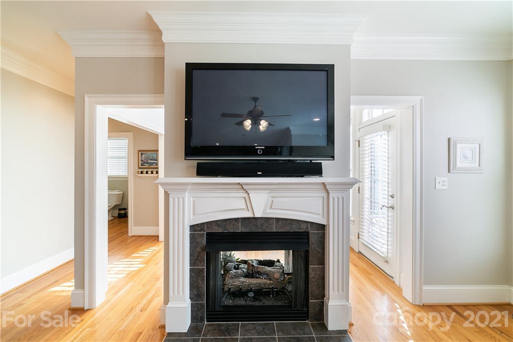 268 Hemmingway Lane Fort Mill, SC 29708 - Photo 19 of 43 a living room with a fireplace and a flat screen tv