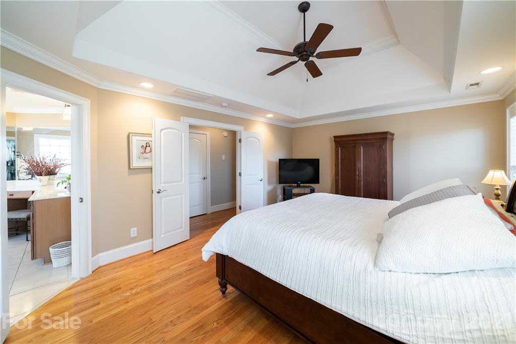 268 Hemmingway Lane Fort Mill, SC 29708 - Photo 27 of 43 a spacious bedroom with a bed and a chandelier