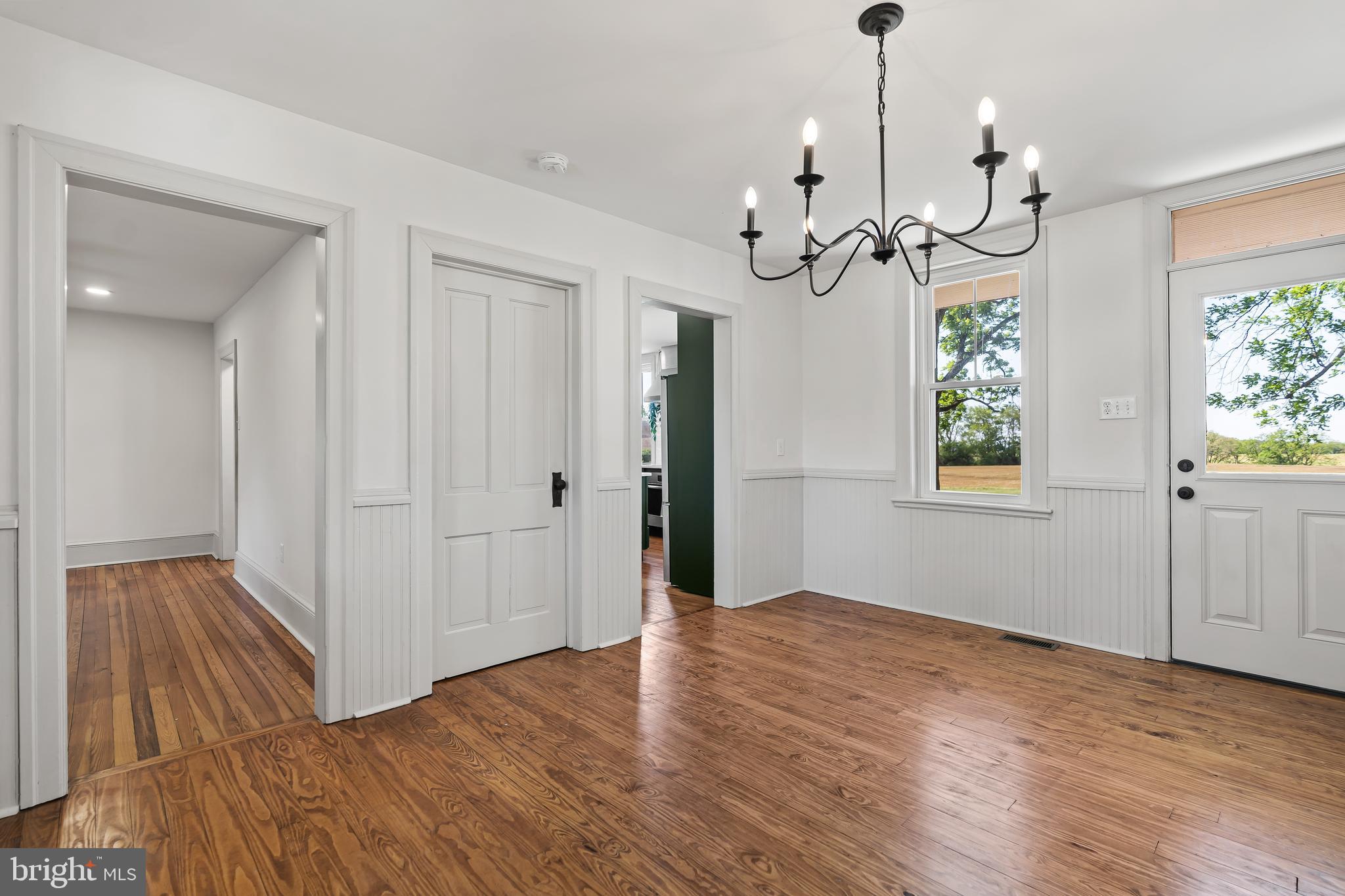14005 Dry Run Road Clear Spring, MD 21722 - Photo 24 of 44 a view of a chandelier in a room with wooden floor and windows