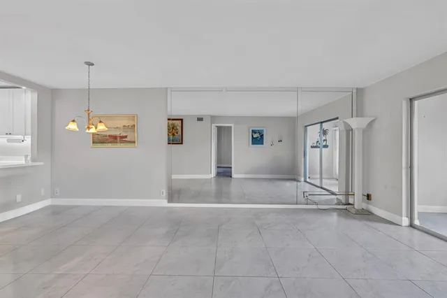 an empty room with a empty space and windows