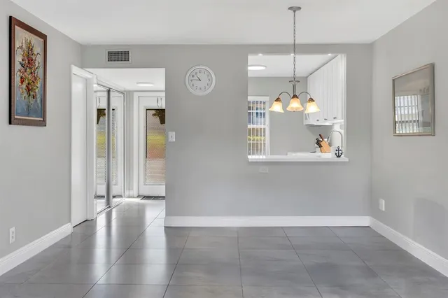 a view of an entryway with wooden floor and a window