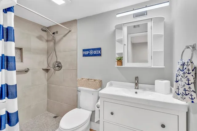 a bathroom with a sink toilet and shower