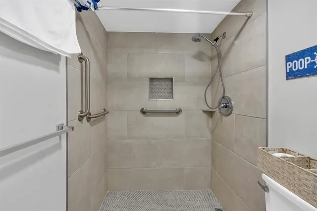 a bathroom with a granite countertop shower