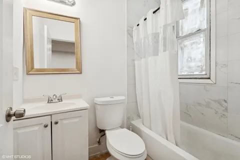 a white toilet sitting next to a bathroom sink