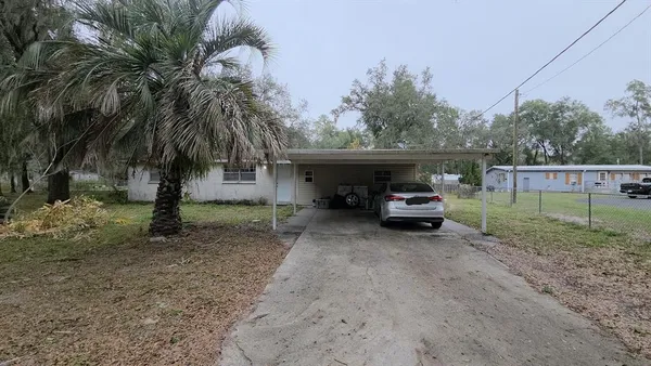 a view of a house with a back side parked space