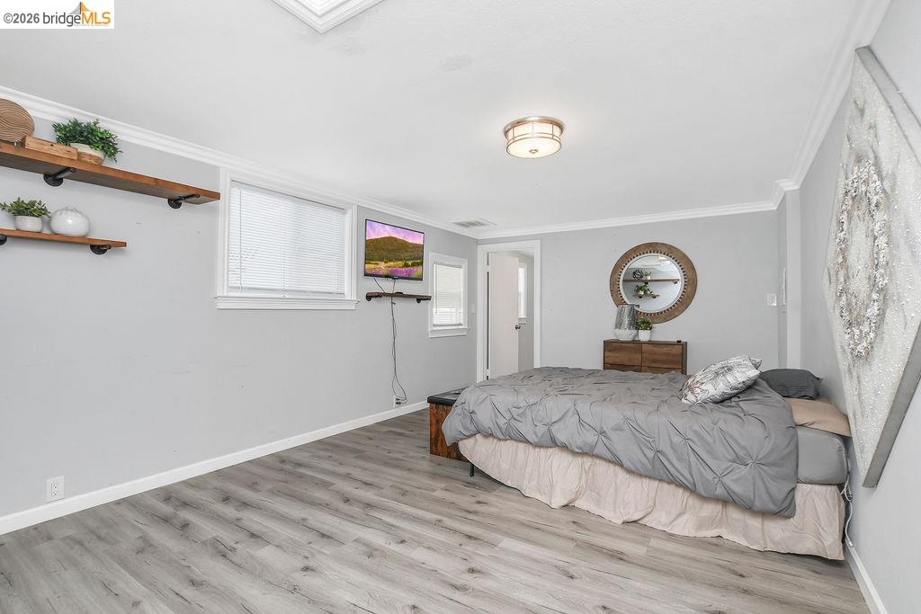 2191 East Cypress Road Oakley, CA 94561 - Photo 19 of 48 Bedroom with light wood-type flooring and crown molding